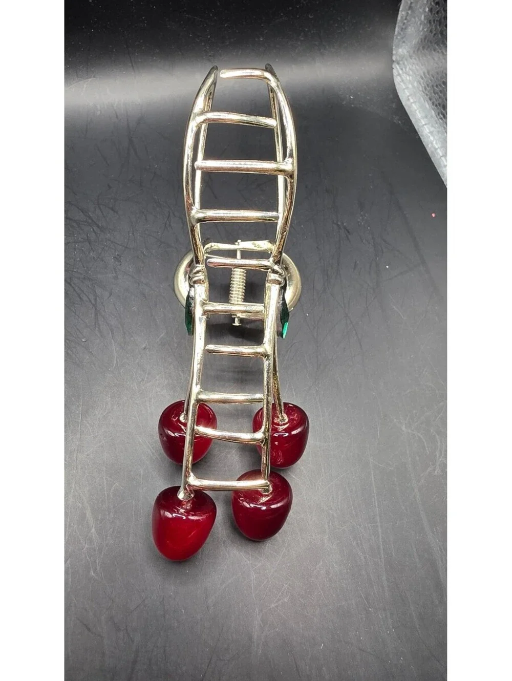 Elegant Gold-Tone Cherry Bow Hair Clip with Red Accents and Green Leaf Detail –